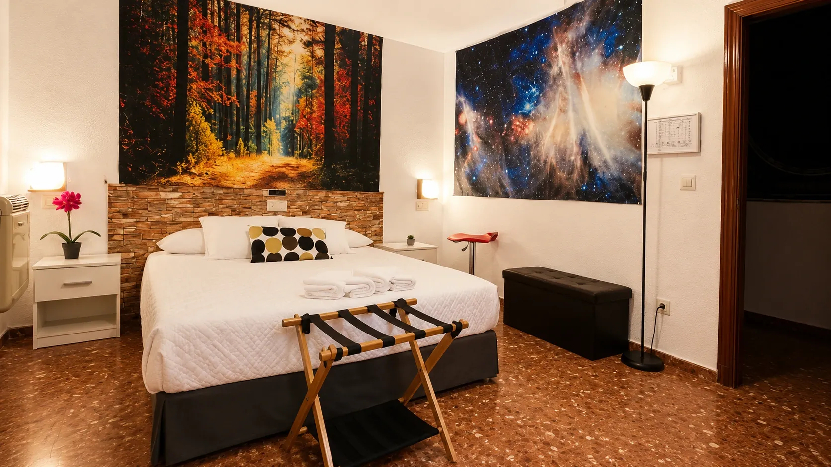 Double room with forest and galaxy wall art at Hotel Al-Ándalus Peal